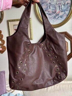 Brown leather tote bag with gold eyelet details